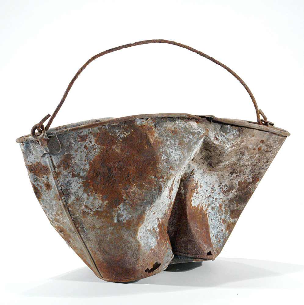 a metal bucket rusted, slightly damaged