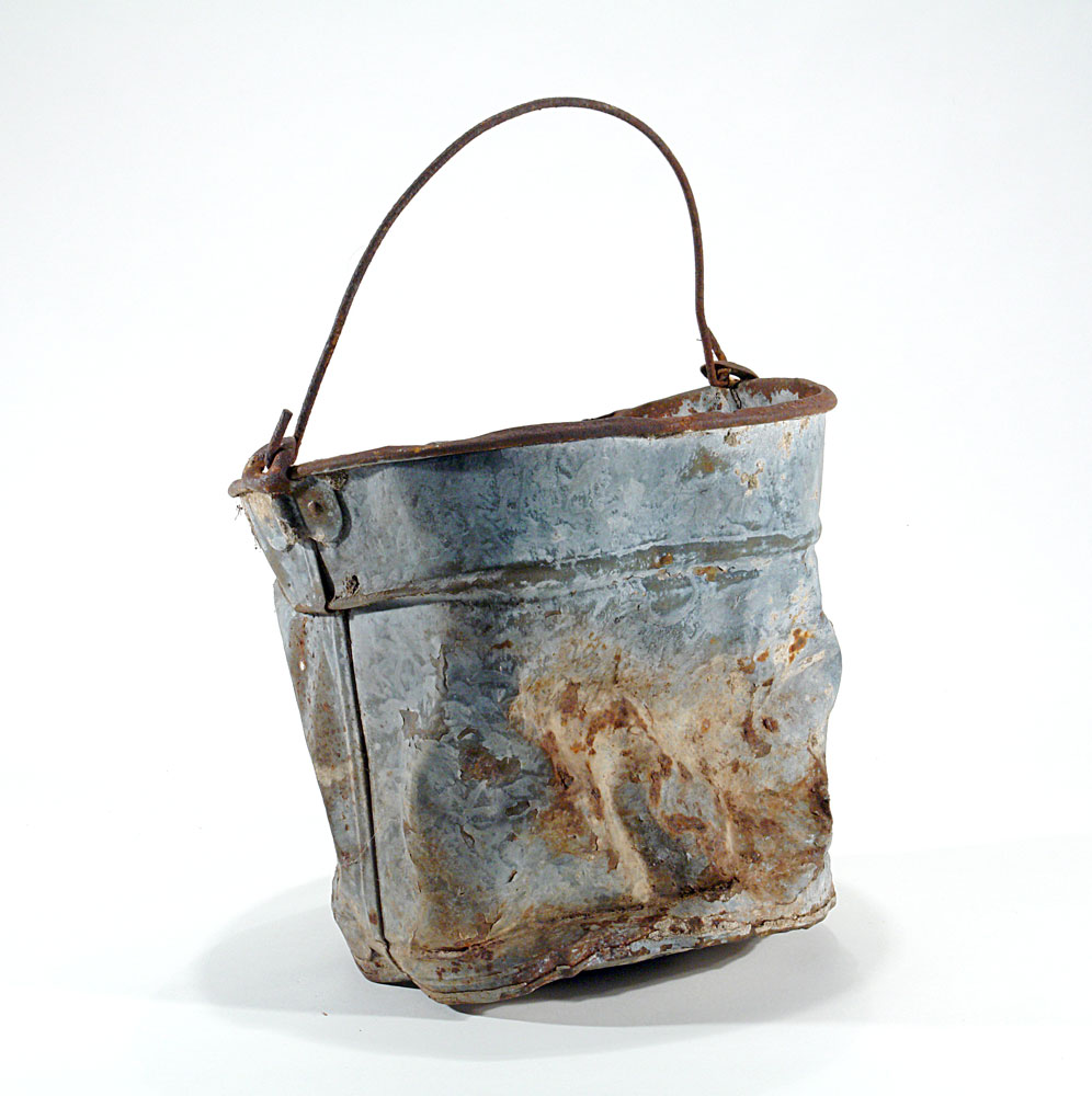a metal bucket rusted, slightly damaged