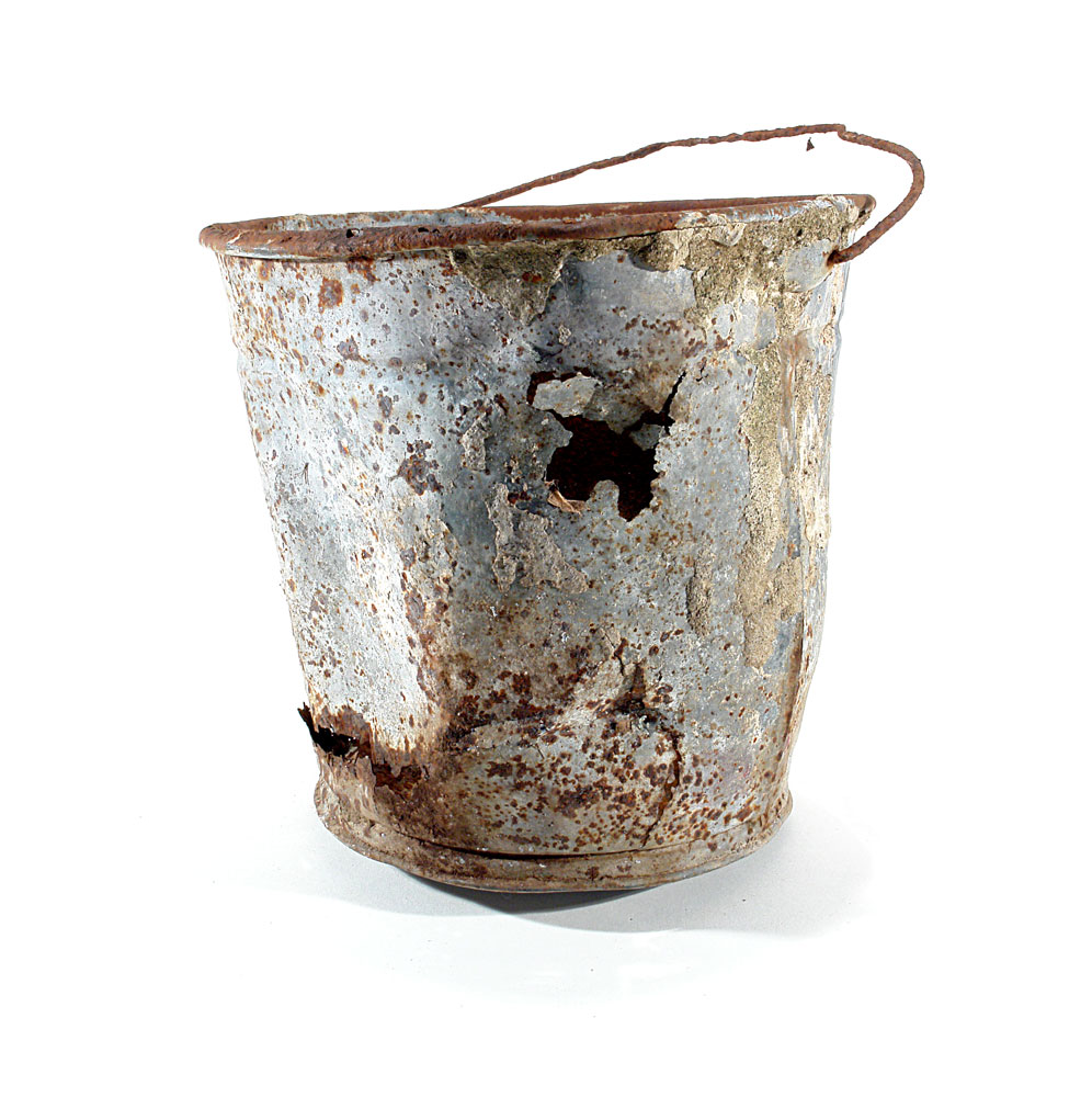 a metal bucket rusted, slightly damaged