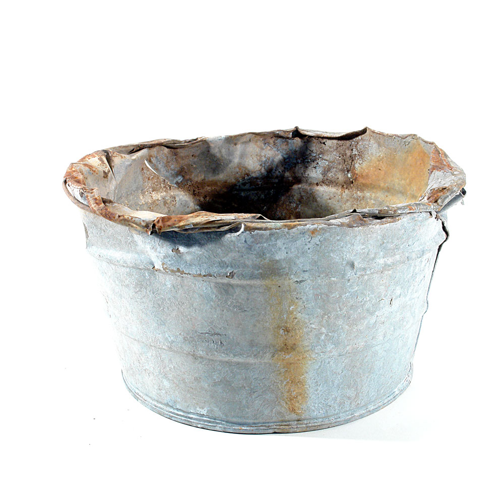 a metal bucket rusted, slightly damaged